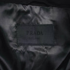 Black fabric care label showing PRADA printed text