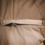 Tan Prada jacket close-up of inner seam and woven logo tag