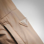 Prada tan jacket sleeve with logo patch near the cuff