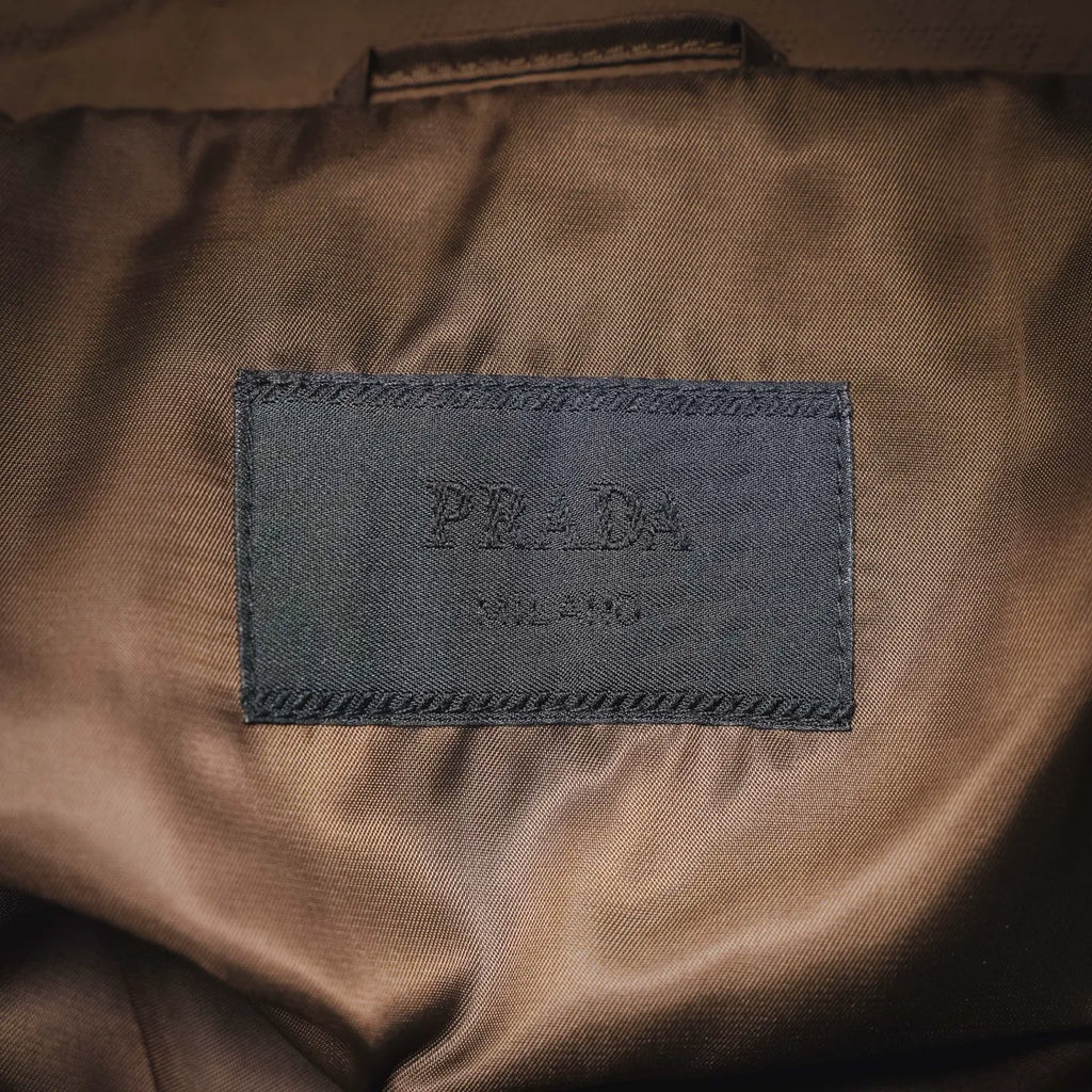 Tan Prada jacket with embroidered logo label on inner lining