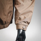 Tan jacket sleeve cuff with snap button detail