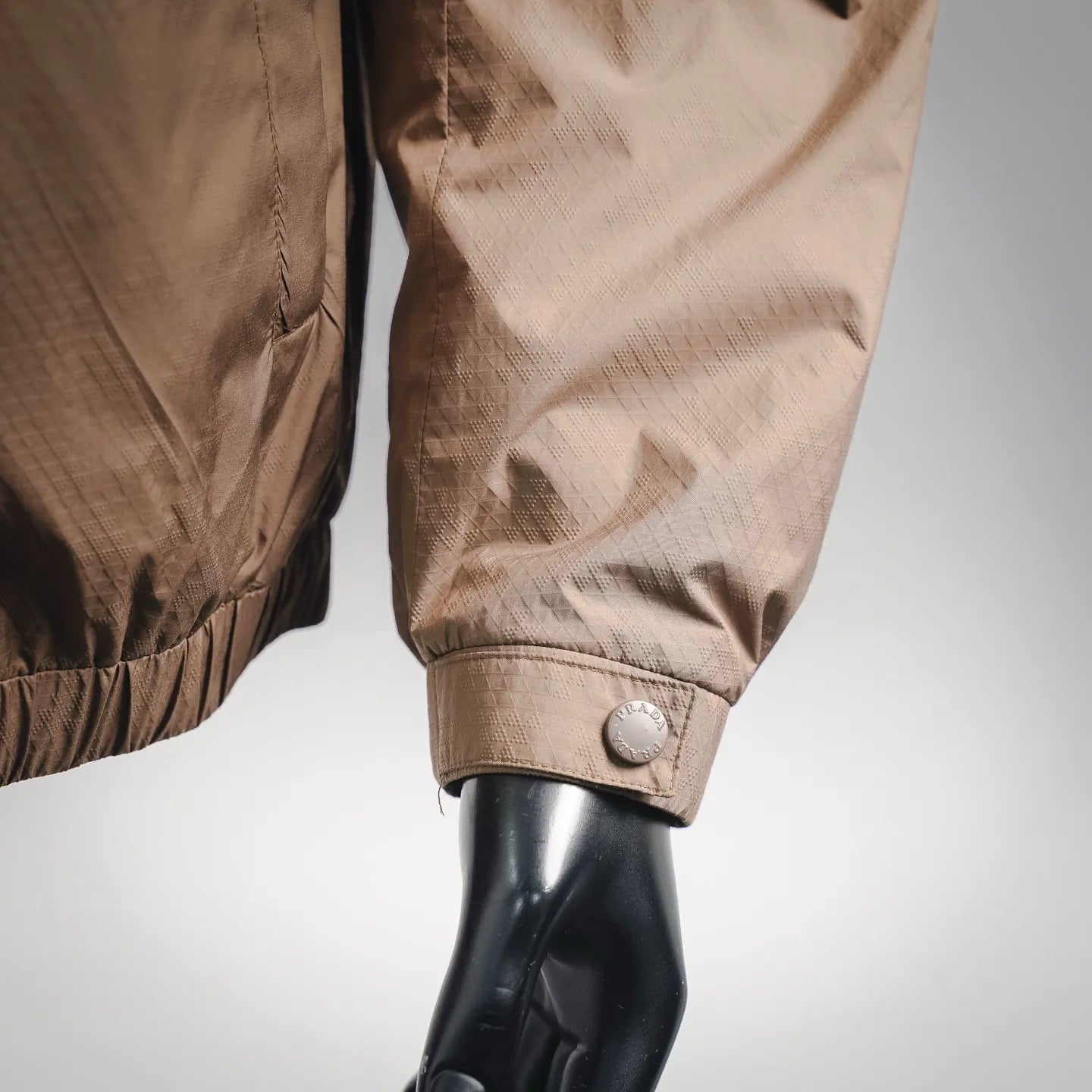 Tan jacket sleeve cuff with snap button detail