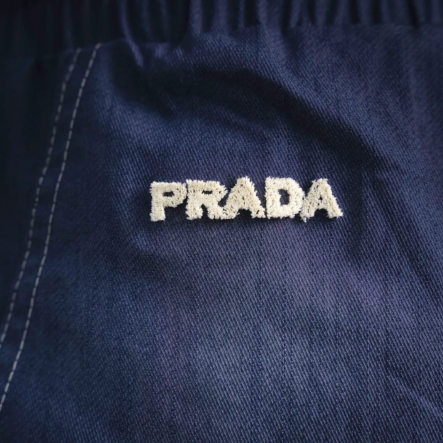 Prada logo patch on blue shorts fabric
