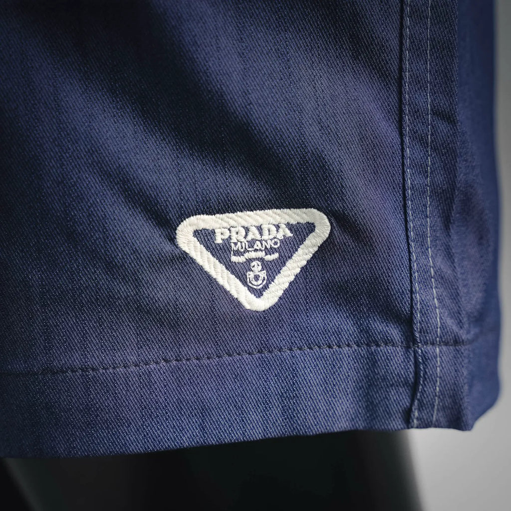 Prada Milano label on blue shorts pocket