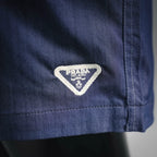 Prada Milano label on blue shorts pocket