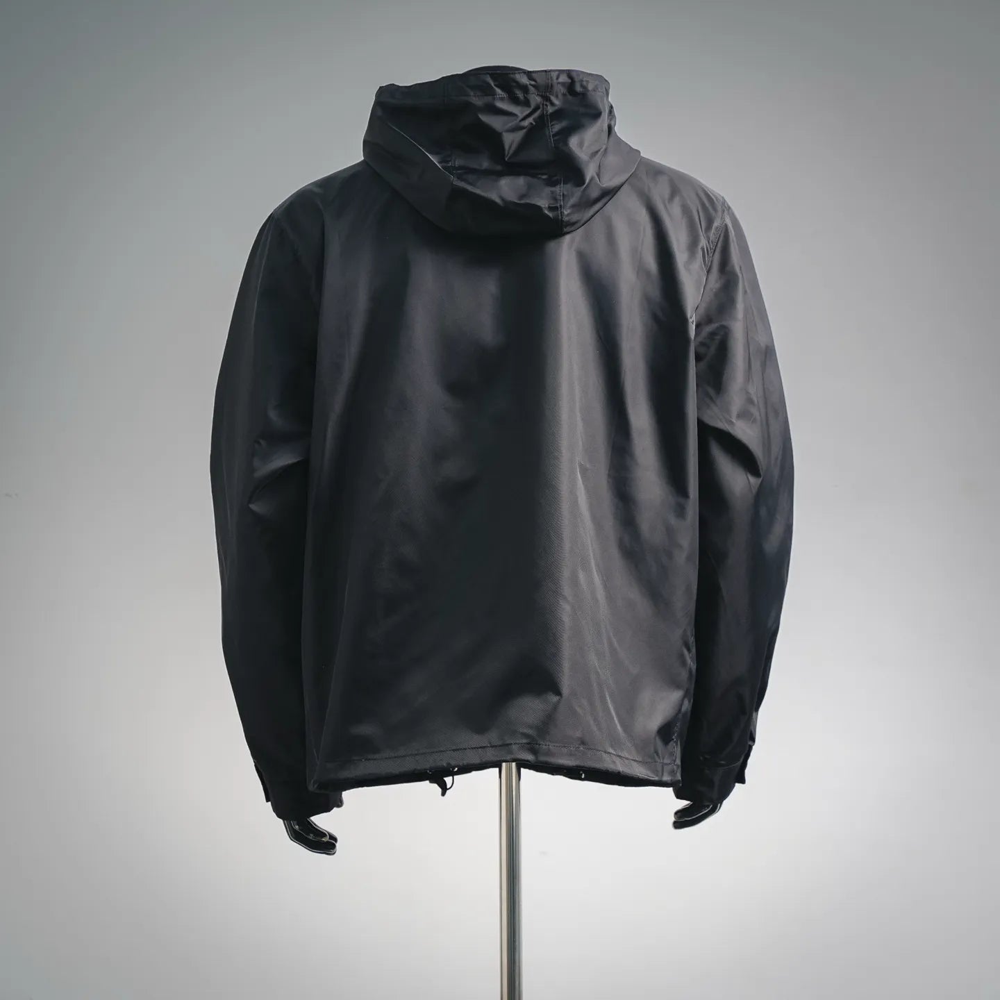 Black hooded zip jacket with full back view and curved hem detail
