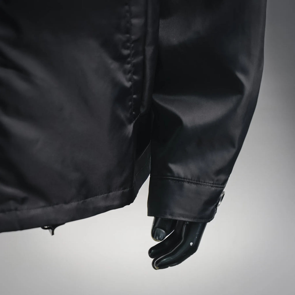 Black jacket front lower section with zipper fly and cuff hem
