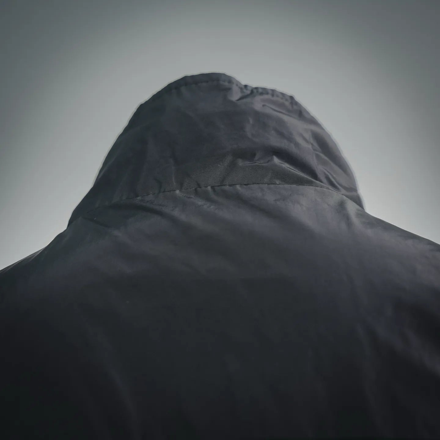 Black nylon hood with structured crown and raised collar