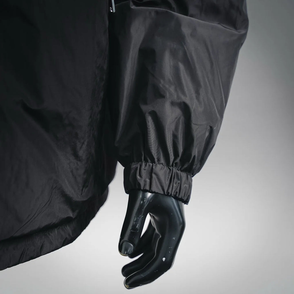 Black nylon jacket sleeve with elastic cuff on mannequin hand