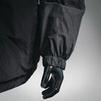 Black nylon jacket sleeve with elastic cuff on mannequin hand