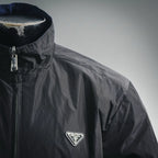 Black nylon jacket front with zipper and triangular Prada chest logo patch