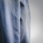 Close-up of light blue denim fabric with textured weave