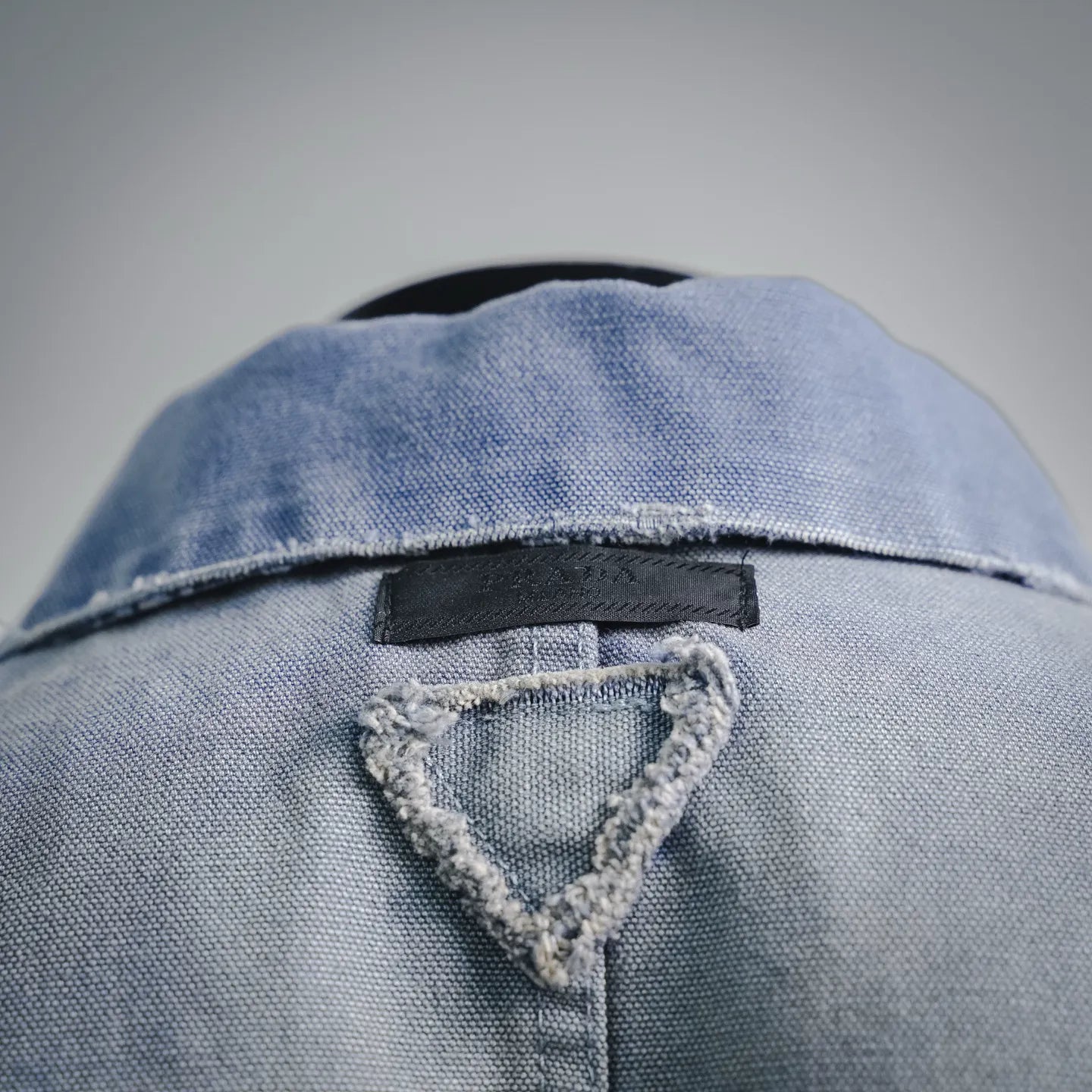 Light blue denim jacket back yoke with triangular inner label