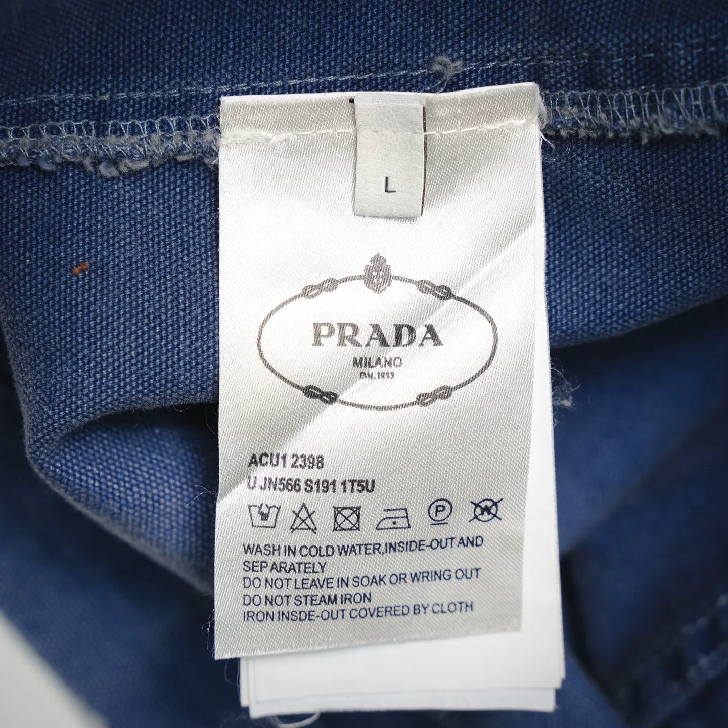 Prada label on light blue denim jacket size L