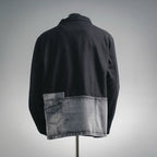 Black zip jacket with gray denim hem panel, back view on mannequin