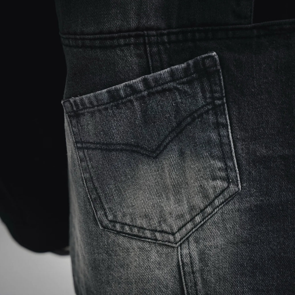 Denim front pocket with stitched panel detail on black jacket