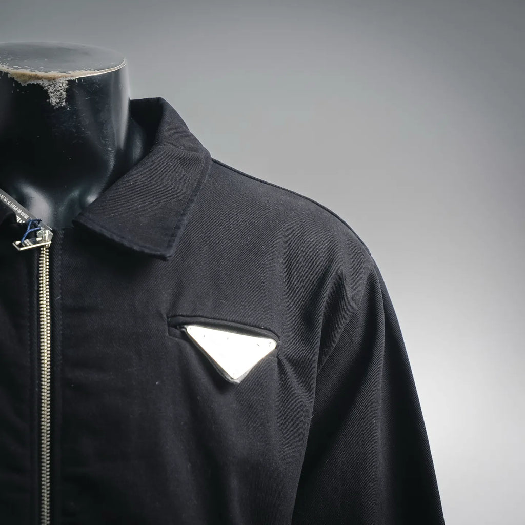 Black jacket collar with zipper and triangular chest patch pocket