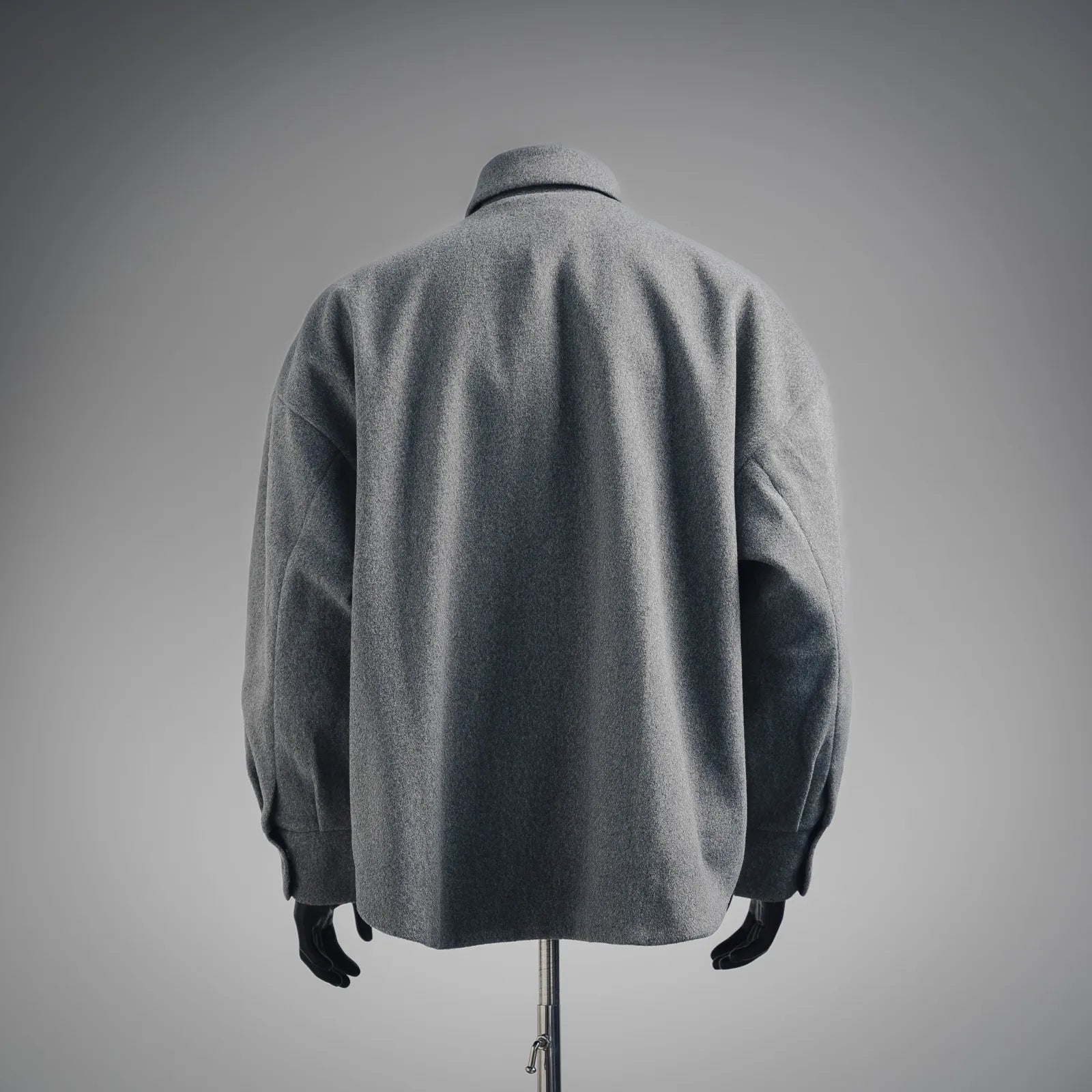 Gray wool jacket back view with full-length sleeves and center-back drape