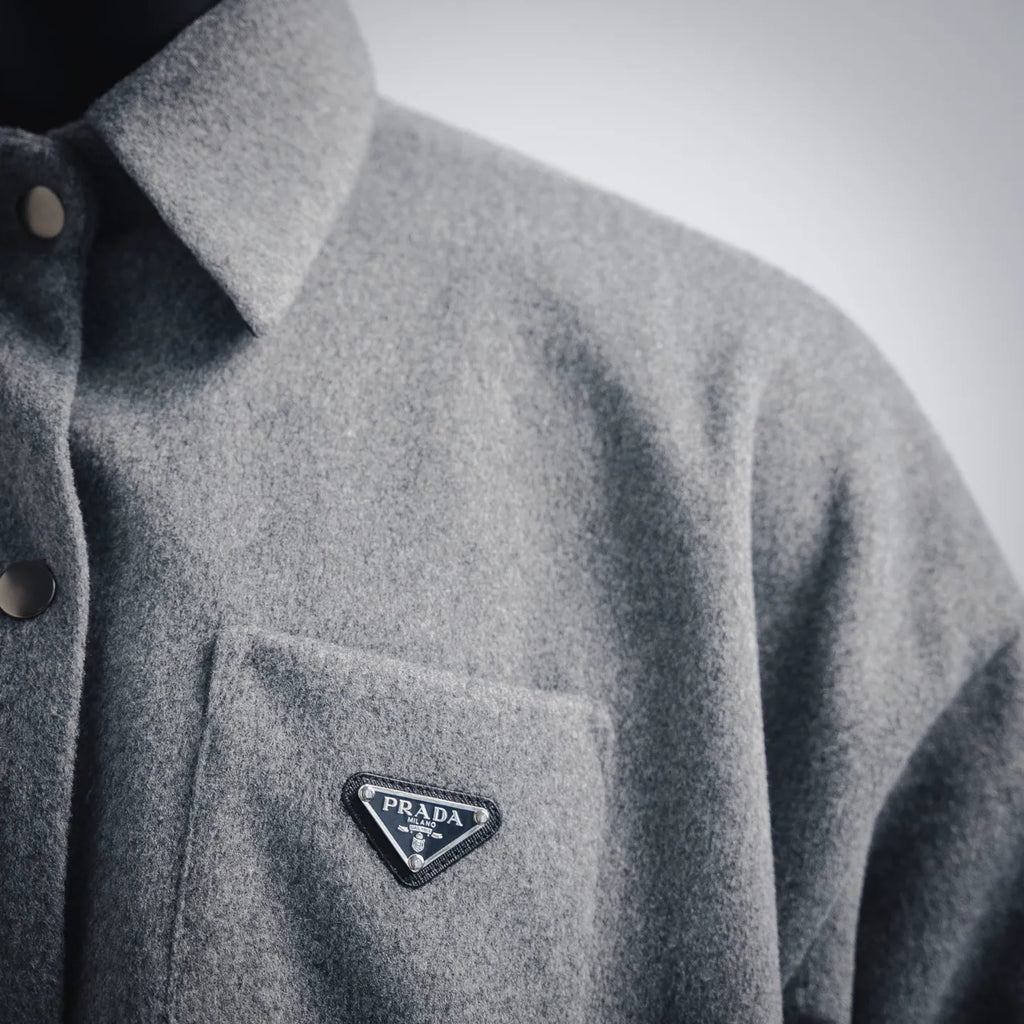 Gray wool jacket chest pocket with Prada triangle logo patch