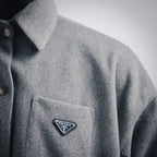 Gray wool jacket chest pocket with Prada triangle logo patch