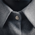 Gray wool jacket neckline with round button and soft wool texture