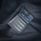 Prada size and care tag on dark fabric lining, marked "L"
