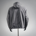 Dark gray hooded jacket with front zip and gathered cuffs, back view