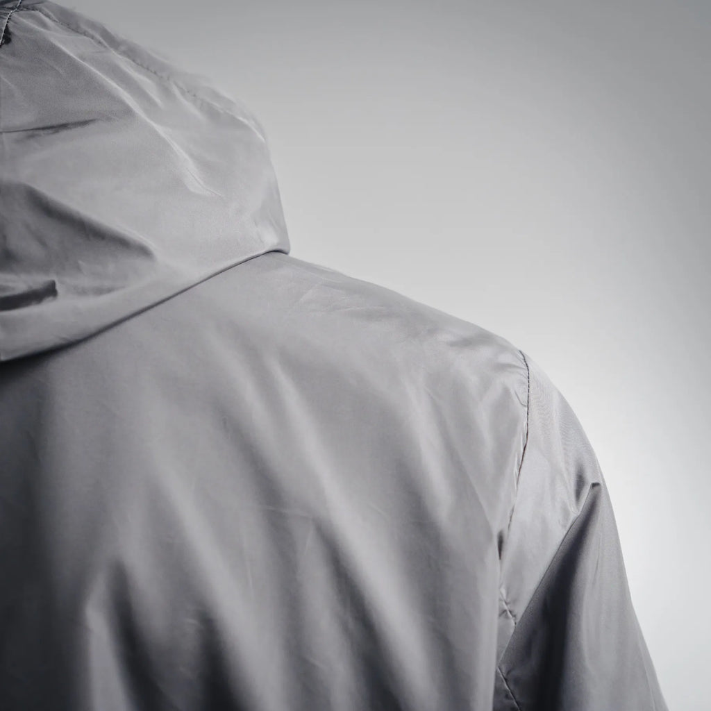 Dark gray hooded jacket with curved shoulder seam, side view