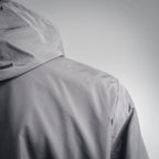Dark gray hooded jacket with curved shoulder seam, side view