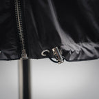 Jacket front hem and zipper pull in dark gray with drawstring toggle detail