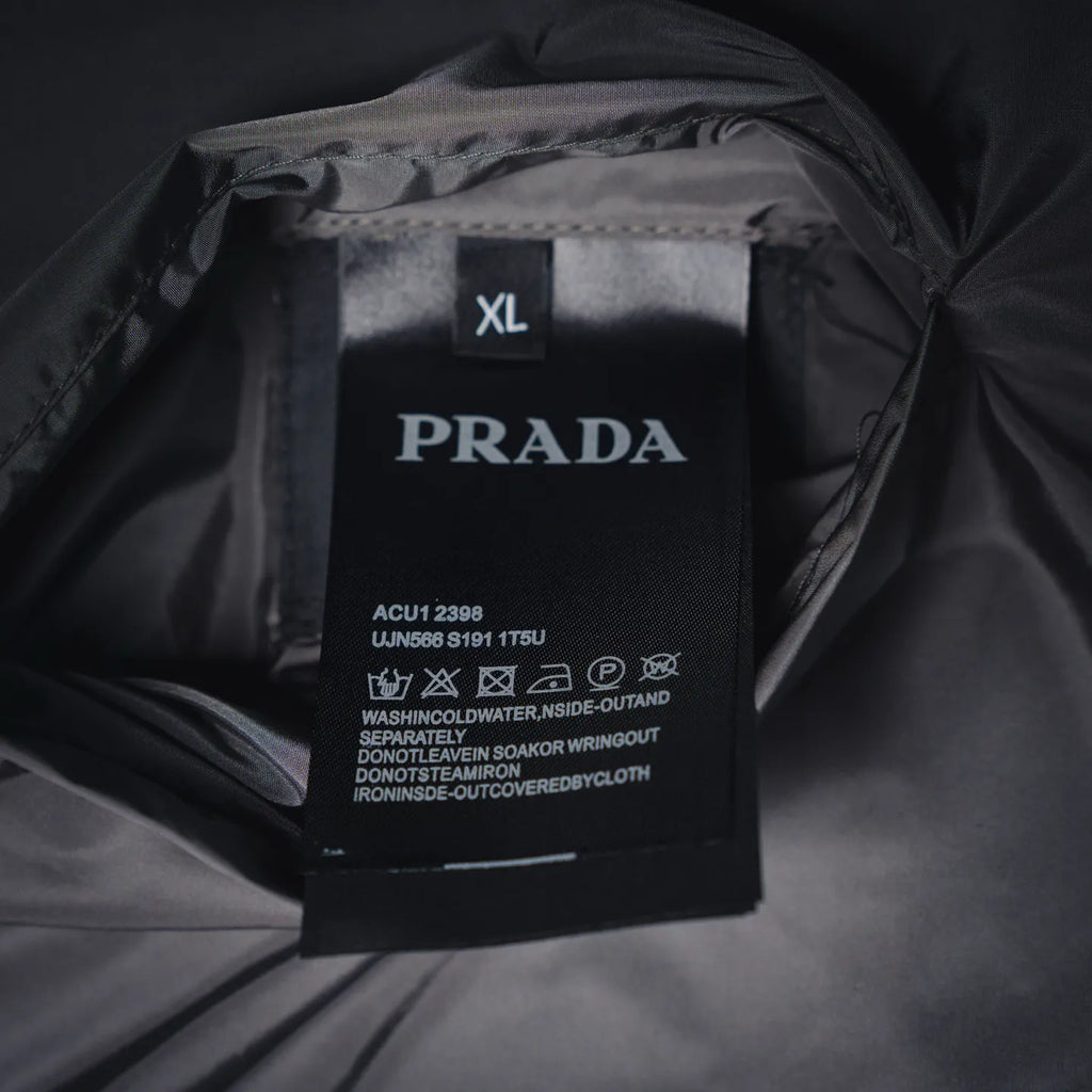 PRADA size XL care label on dark jacket lining, with model and washing instructions