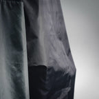 Prada black nylon jacket fabric panel, visible stitching and pocket detail