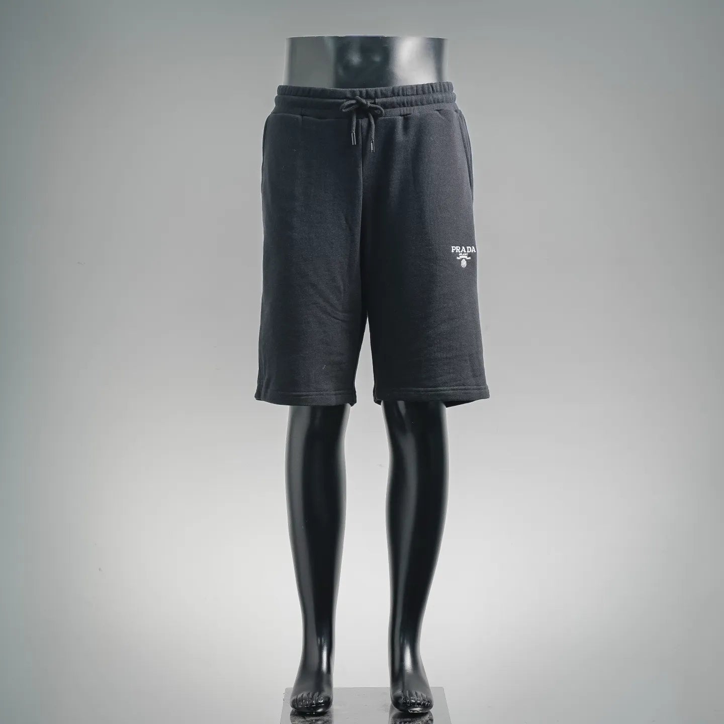 Navy drawstring shorts with elastic waistband and Prada logo patch