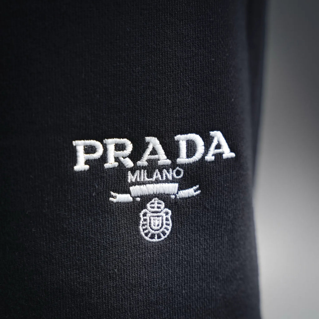 Prada Milano logo patch on dark shorts leg