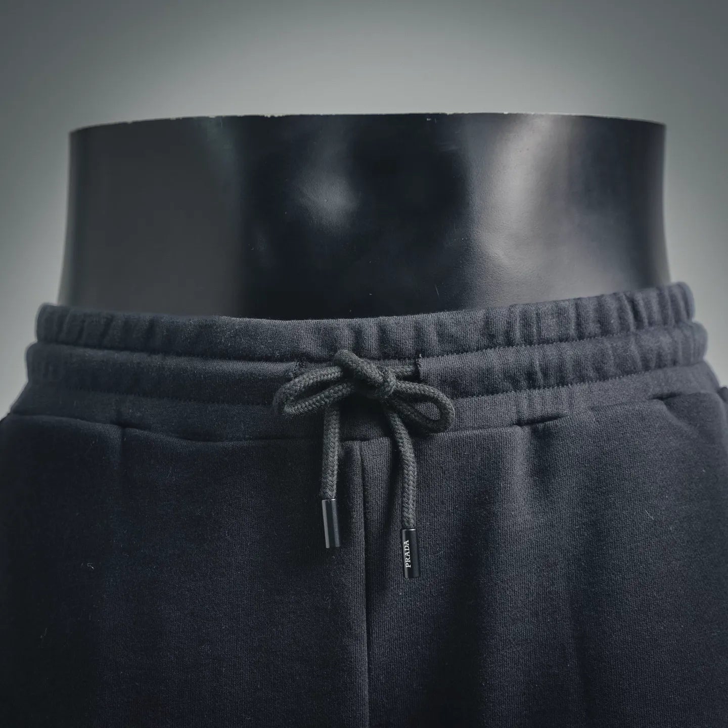 Dark drawstring shorts with elastic waistband and knot detail