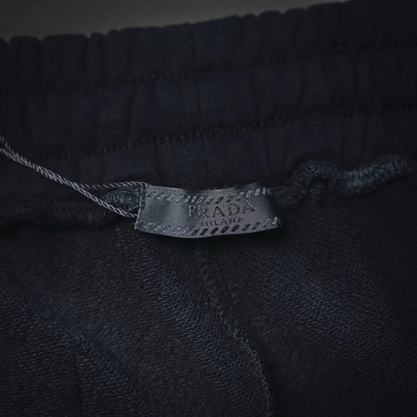Prada label inside dark shorts waistband seam