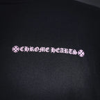 Chrome Hearts logo text close-up on dark hoodie fabric.