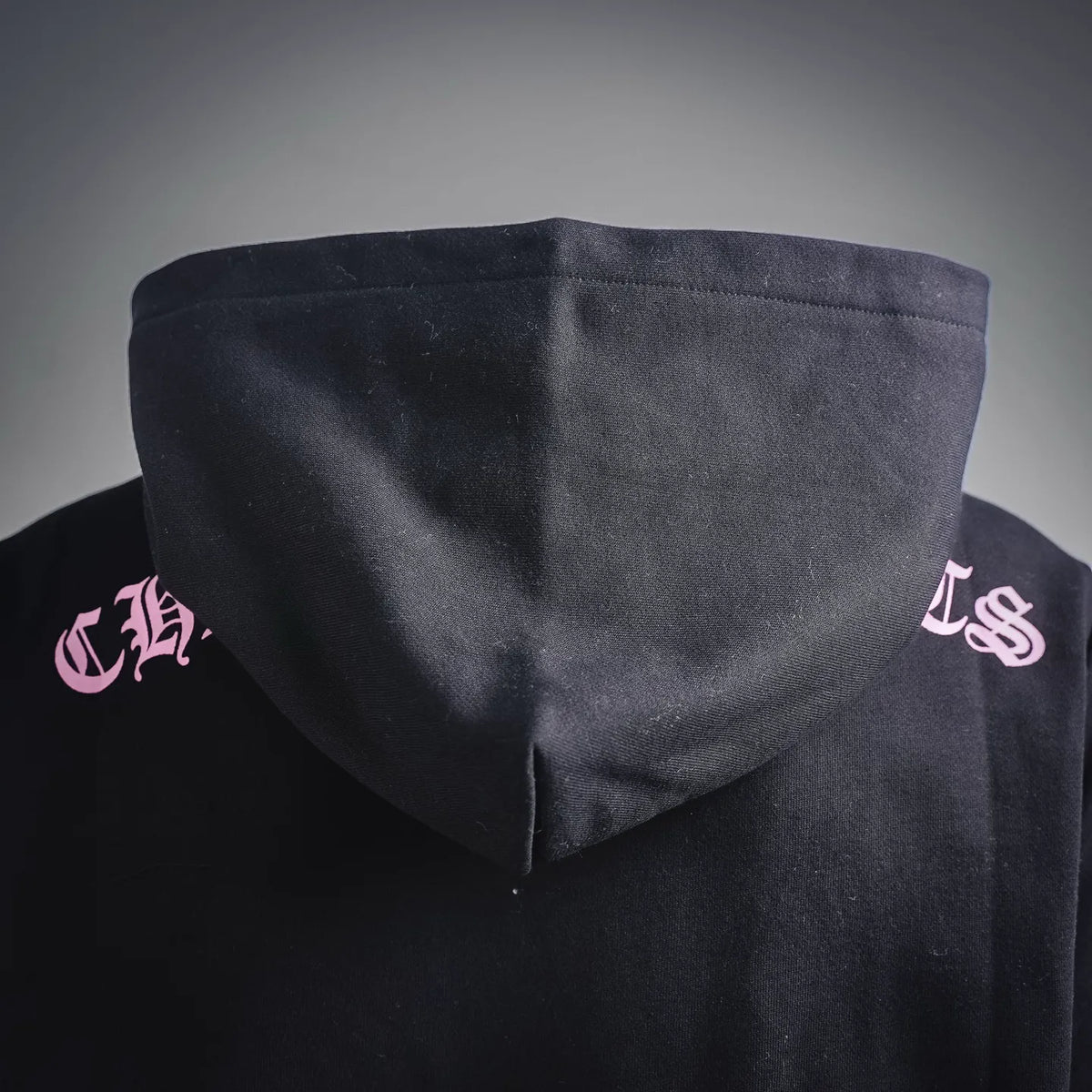 Chrome Hearts hoodie back hood area with small pink side logo prints.