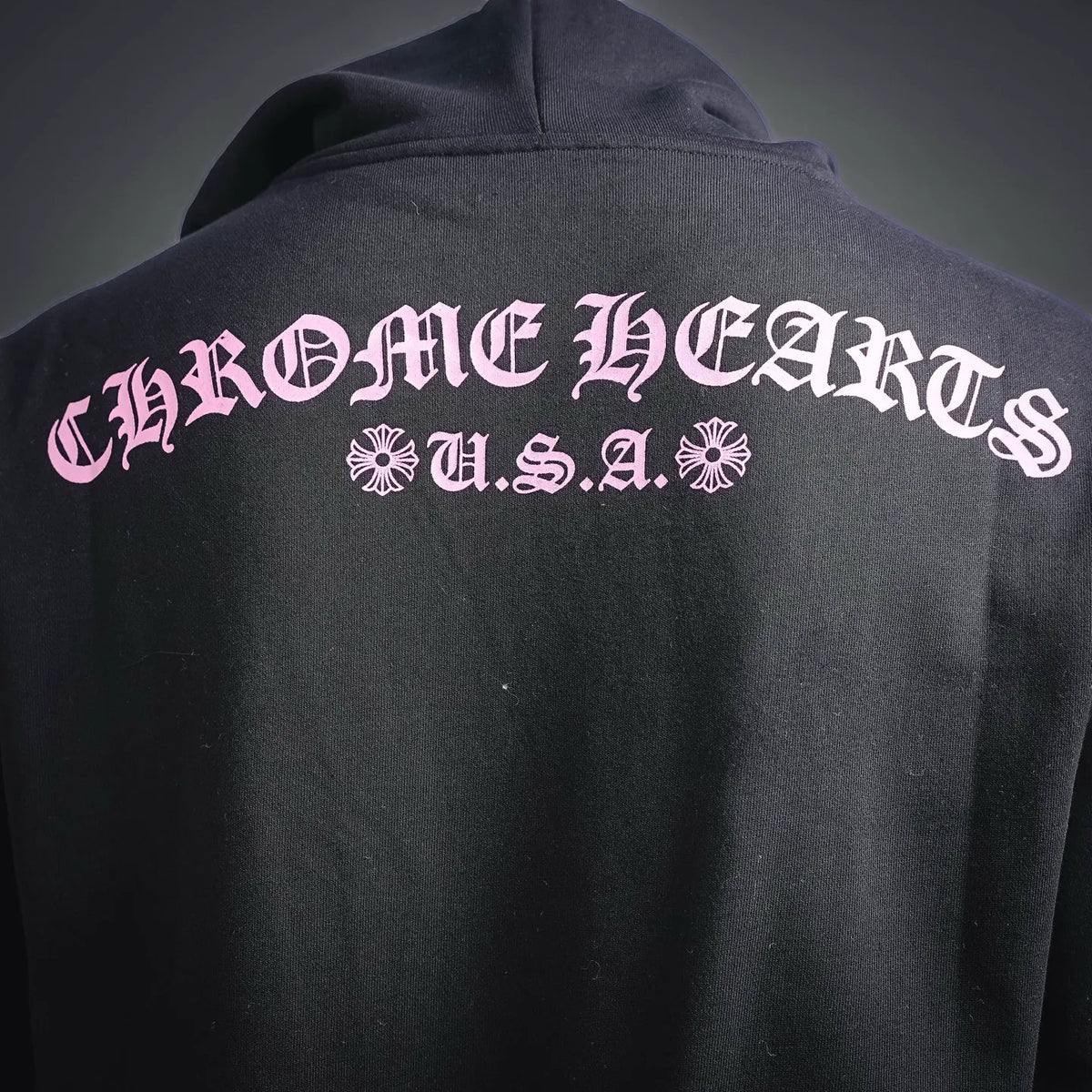 Chrome Hearts long-sleeve hoodie back with large pink logo and text across shoulder.