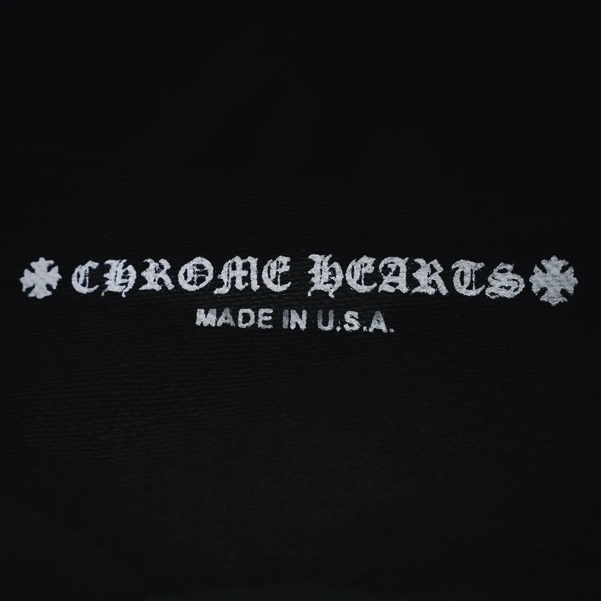 Chrome Hearts logo on hoodie fabric with “MADE IN U.S.A.” text.