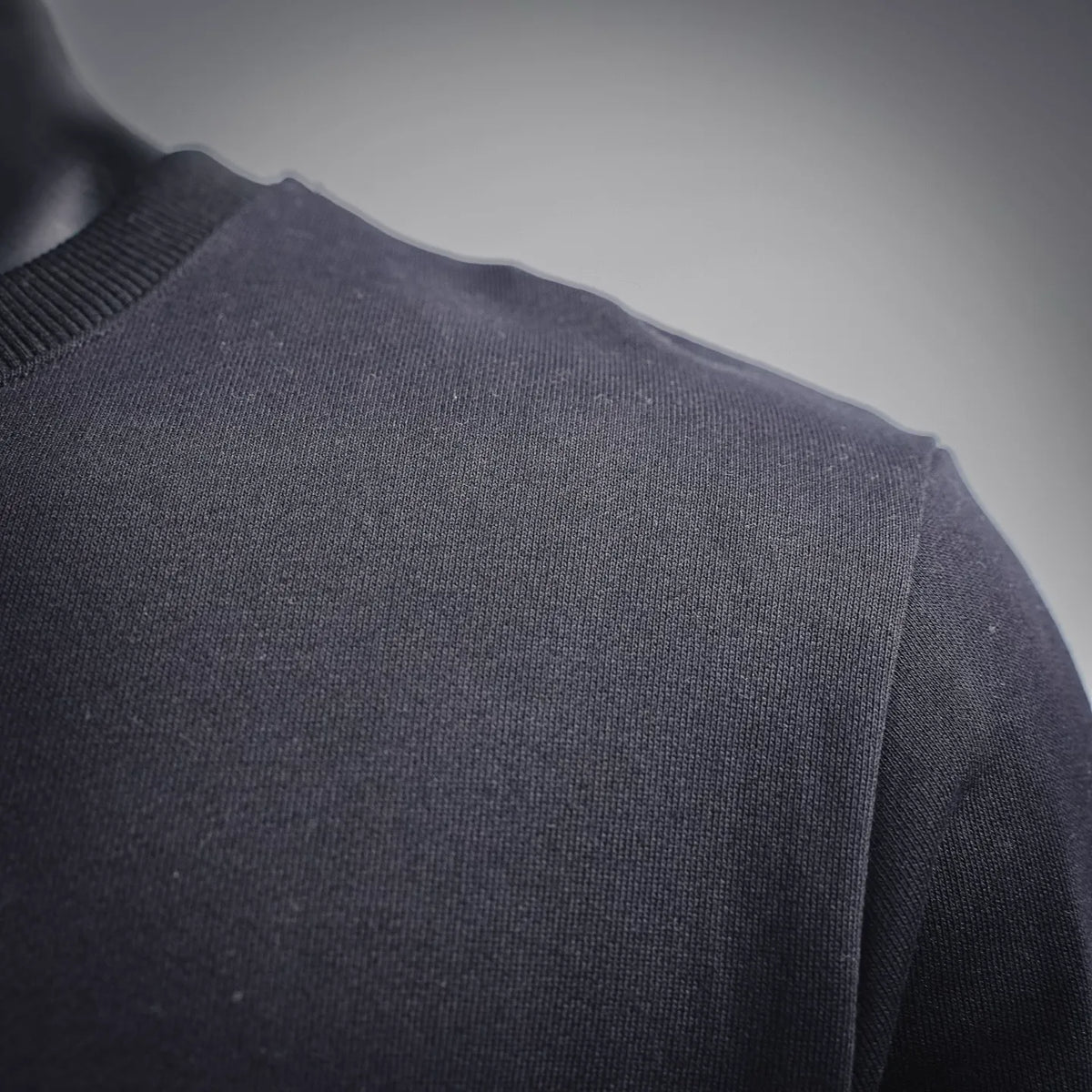 Black sweatshirt fabric and shoulder seam close-up