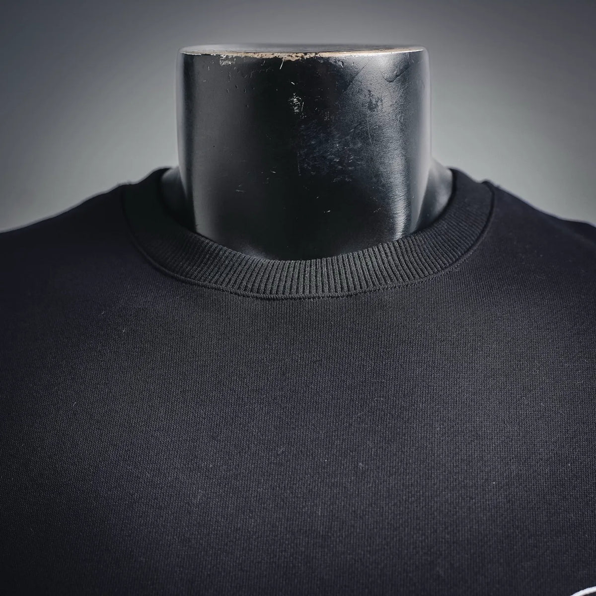 Black sweatshirt collar with ribbed crew neckline close-up