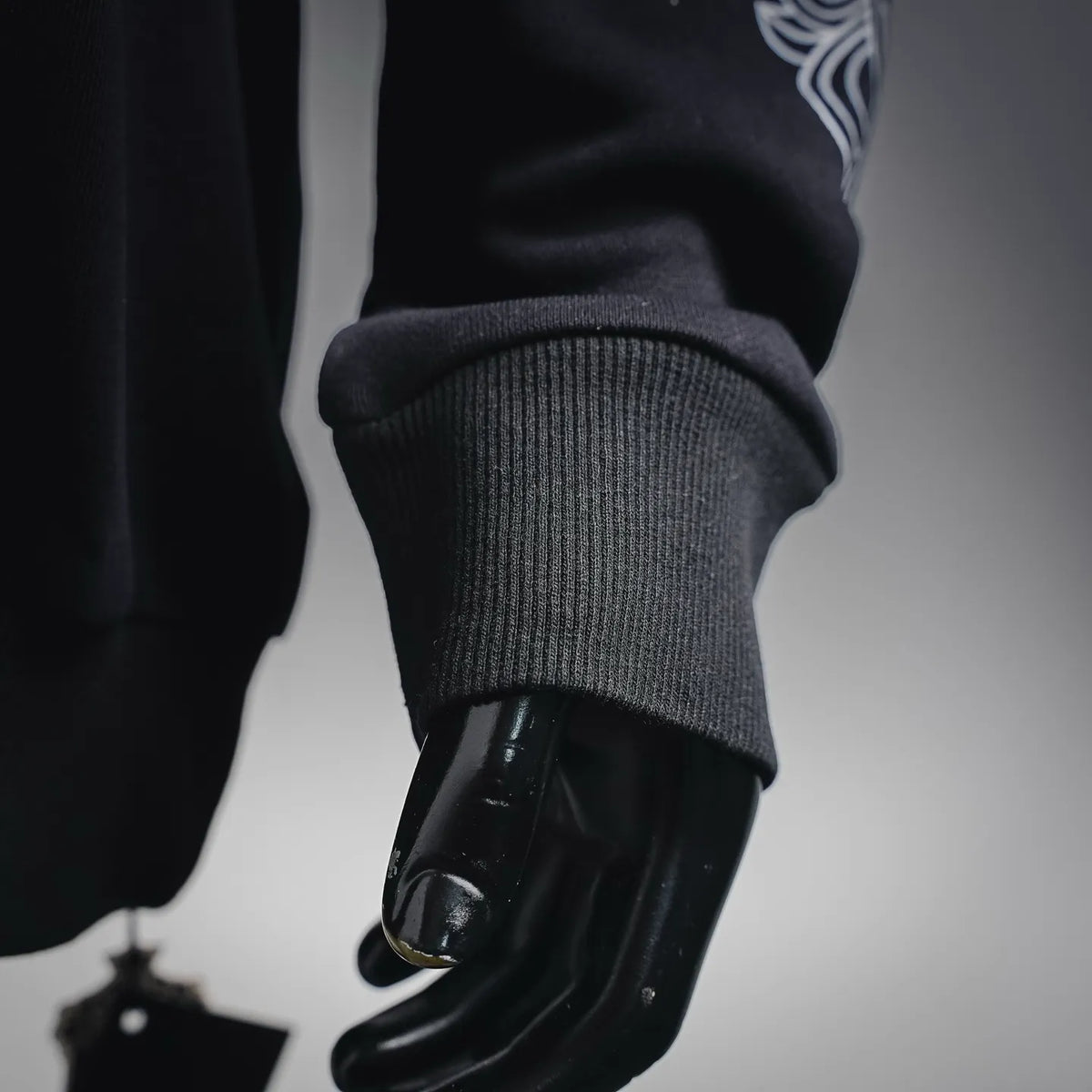 Black sweatshirt sleeve cuff with ribbed hem detail