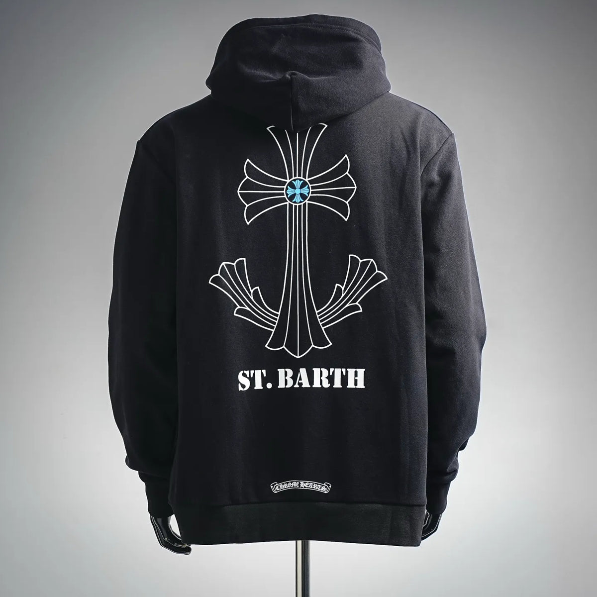 Black pullover hoodie with large back cross graphic and 'ST. BARTH' text.