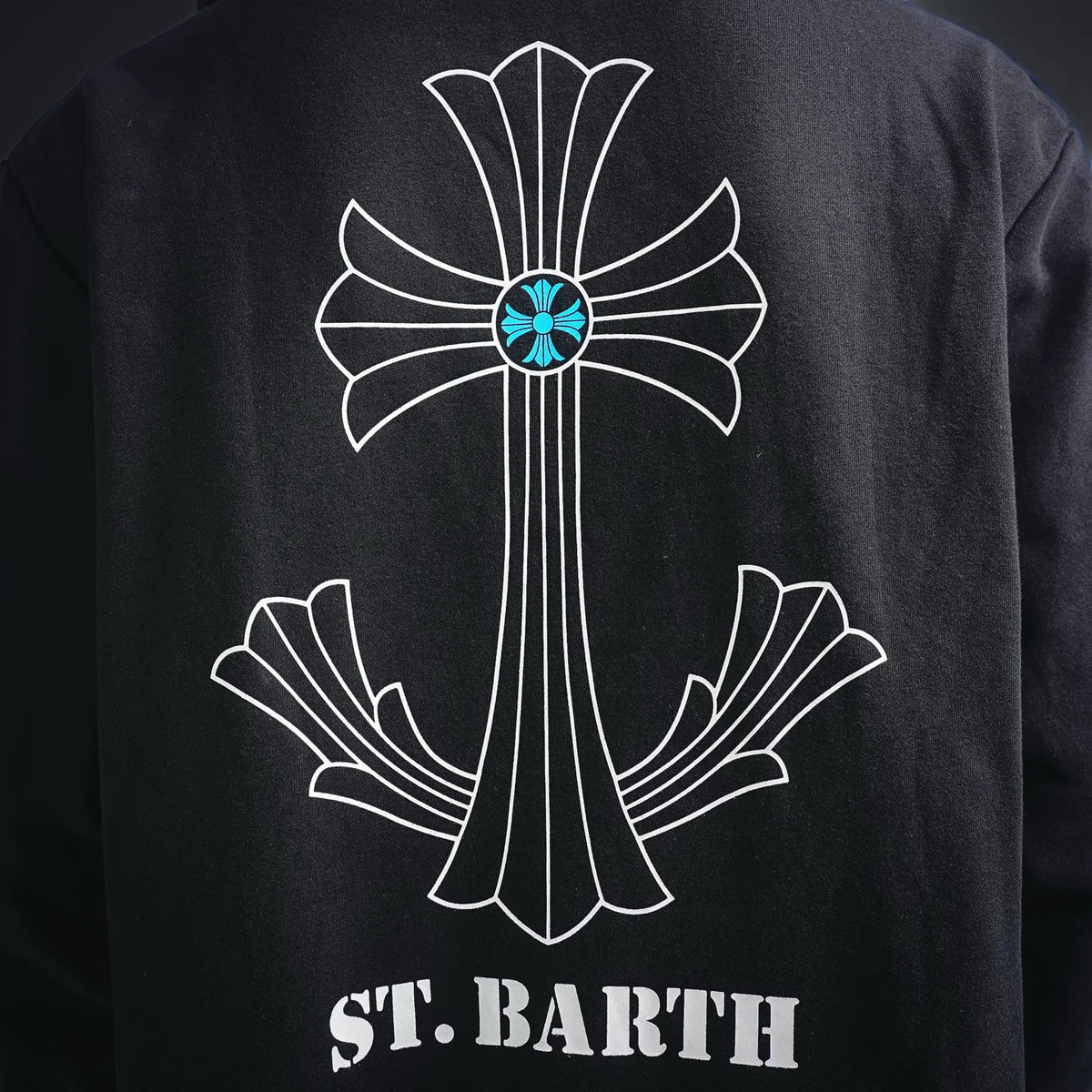 Black hoodie back with large white cross outline and 'ST. BARTH' below.