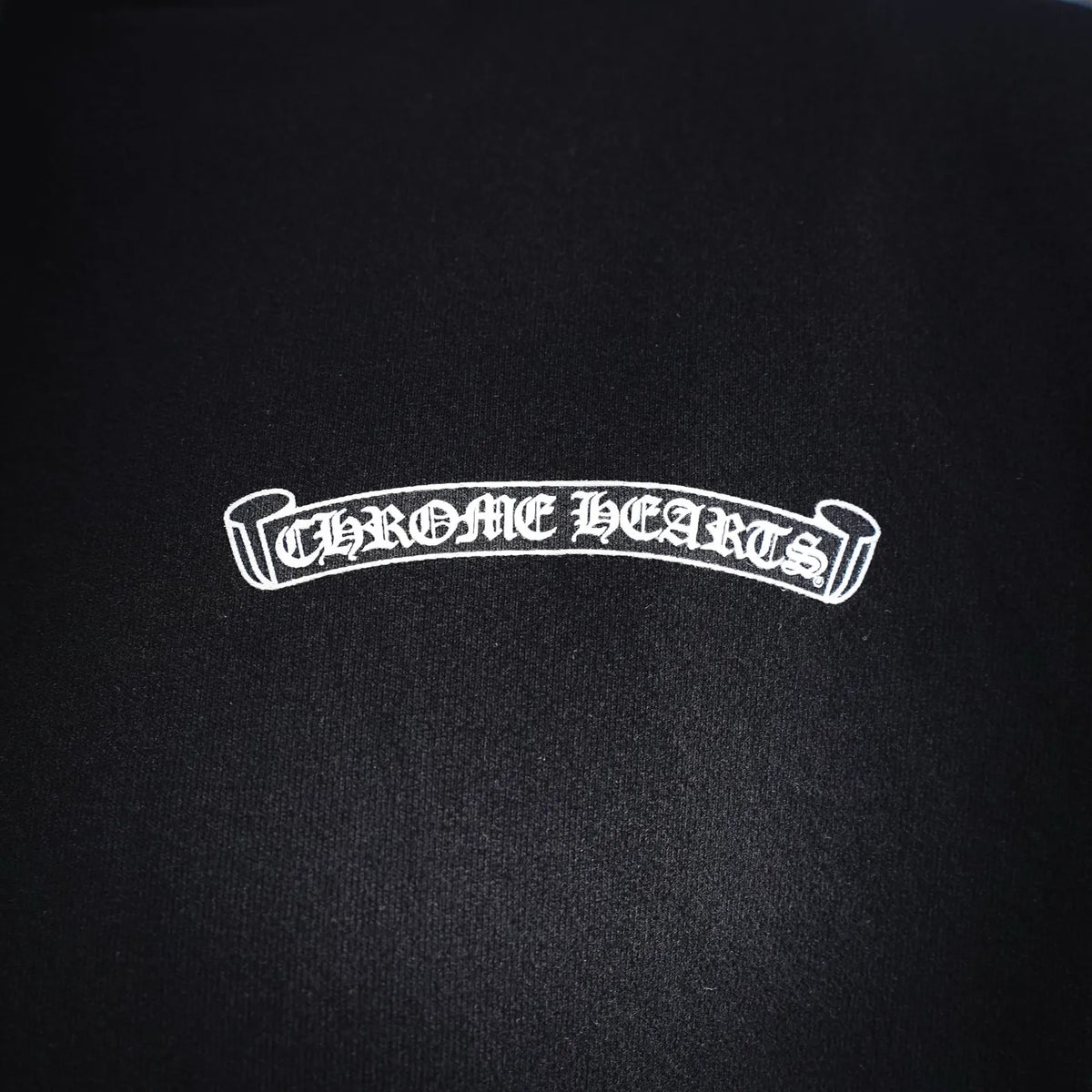 Black hoodie chest logo patch with 'CHROME HEARTS' text in white.