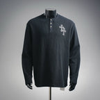 Dark long-sleeve henley shirt with button placket and silver cross patch