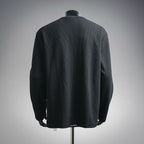 Dark long-sleeve henley shirt shown from back on a mannequin