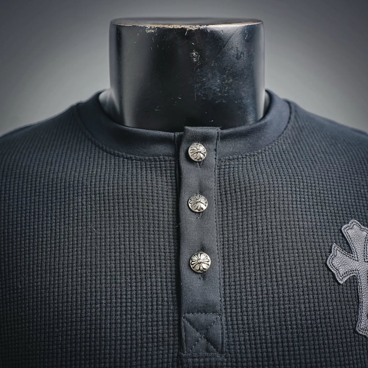Dark henley collar with snap buttons and ribbed neckline