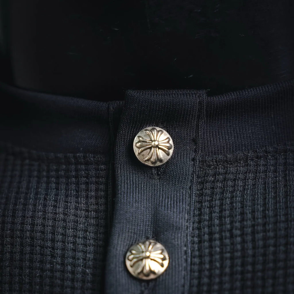Dark henley placket with decorative round snap buttons
